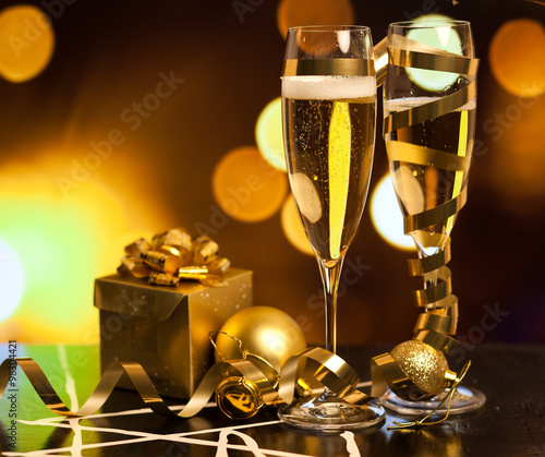 Toasting with champagne glasses against holiday lights