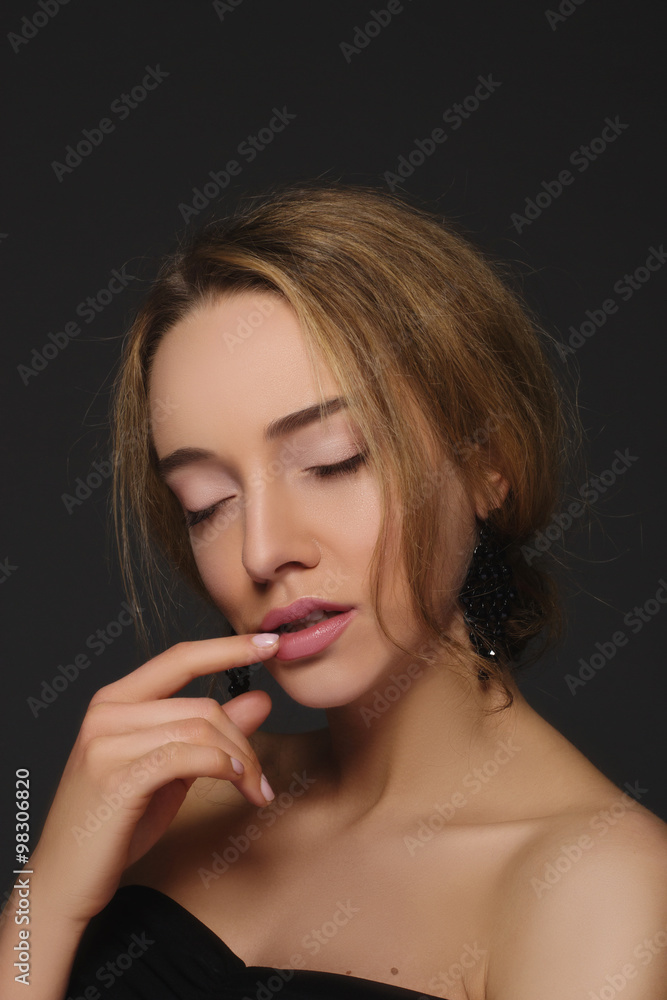 Portrait of beautiful sexy woman with nude make-up. Portrait with finger on lips Portrait of beautiful sexy woman with nude make-up. Portrait with finger on lips