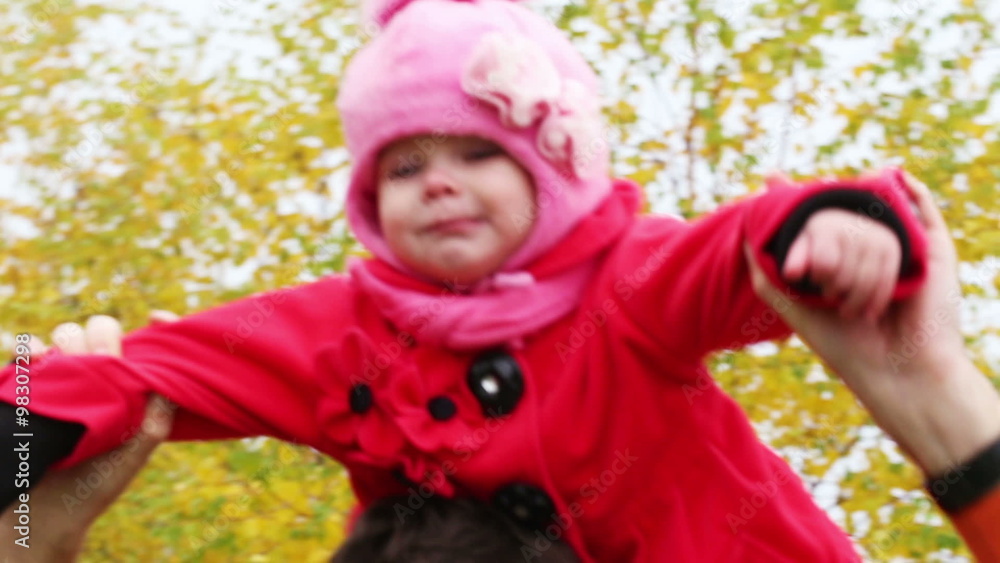 young Dad with a small child having fun in autumn park - closeup, handheld shot young Dad with a small child having fun in autumn park - closeup, handheld shot