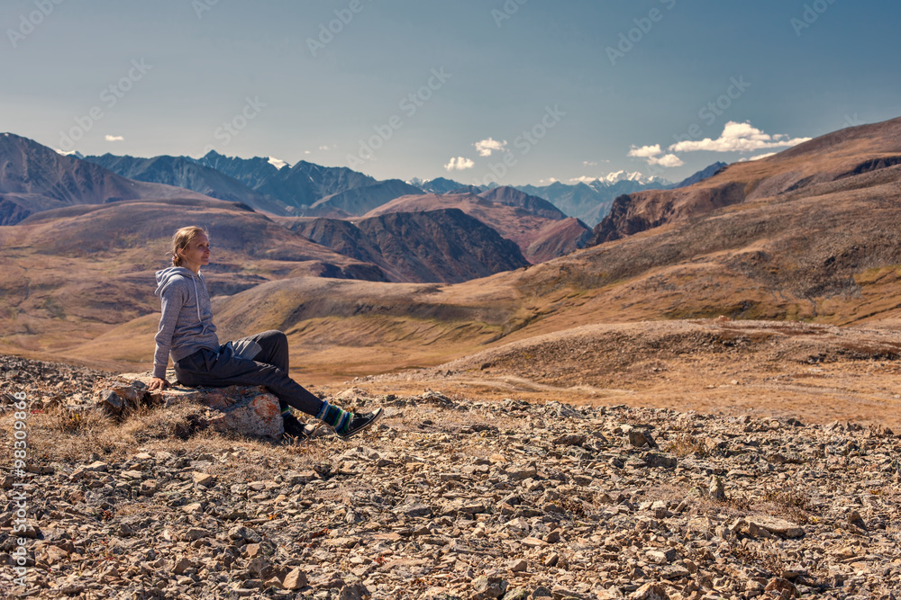 Woman hiker sitting on mountain top, Relax and Enjoy