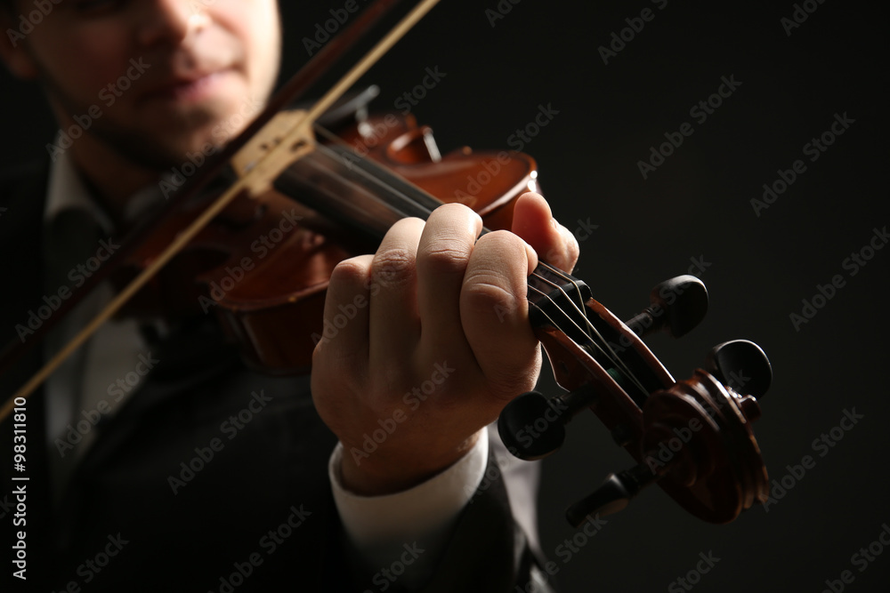 Musician play violin on black background, close up Musician play violin on black background, close up