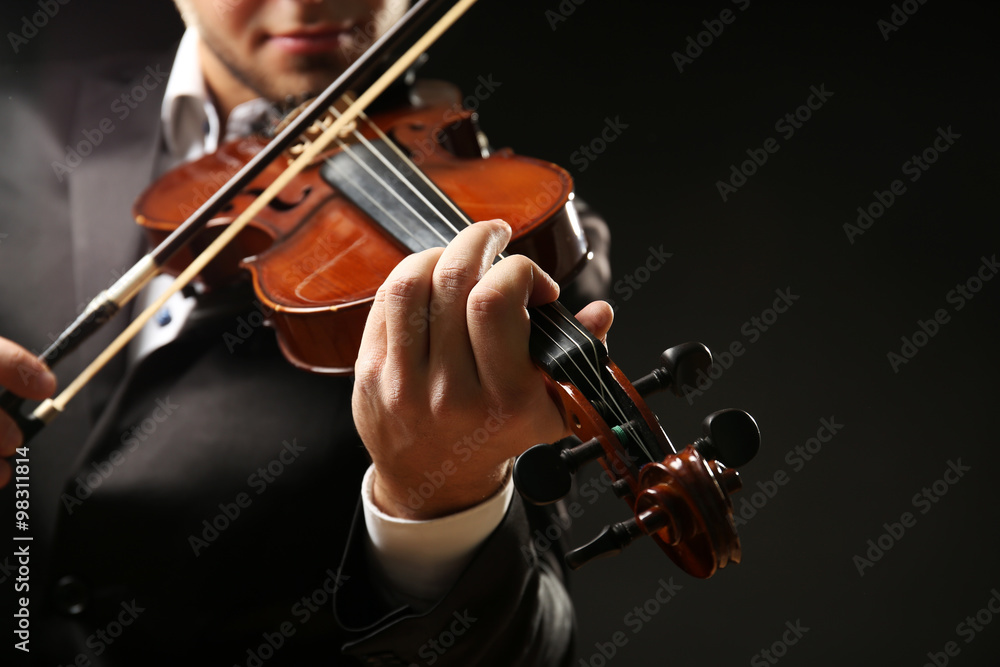 Musician play violin on black background, close up Musician play violin on black background, close up