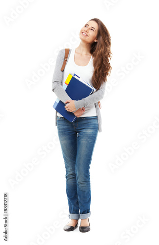 Young happy female student looking looking up isolated.