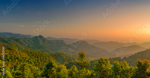 Landscape many mountain tropical forest with orange light of sunrise in Thailand at Chiang Mai