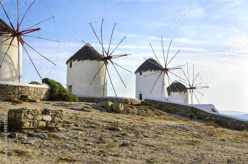 Four windmills in Chora,Mykonos,Greece.Traditional greek whitewashed architecture,a popular landmark,tourist destination on the island of winds,deep blue sky,Aegean sea. Wind mills are now decorative.