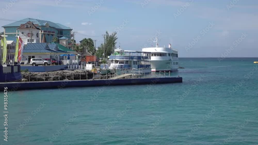 Grand Cayman marina shore boats Caribbean. Cruise ship and vacation travel. Banking investment center. Beach, scuba diving and resorts cater to tourists. Don Despain of Rekindle Photo.