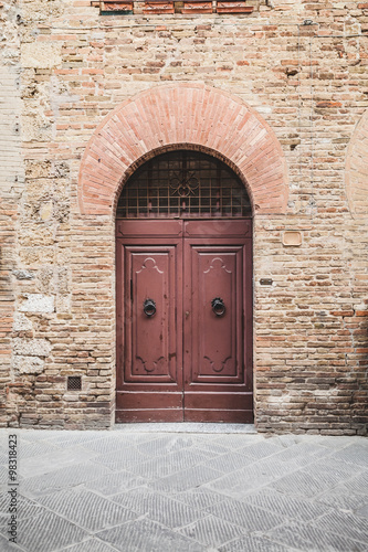 Wallpaper Mural Wooden Door in a Medieval Town of Tuscany, Italy Torontodigital.ca