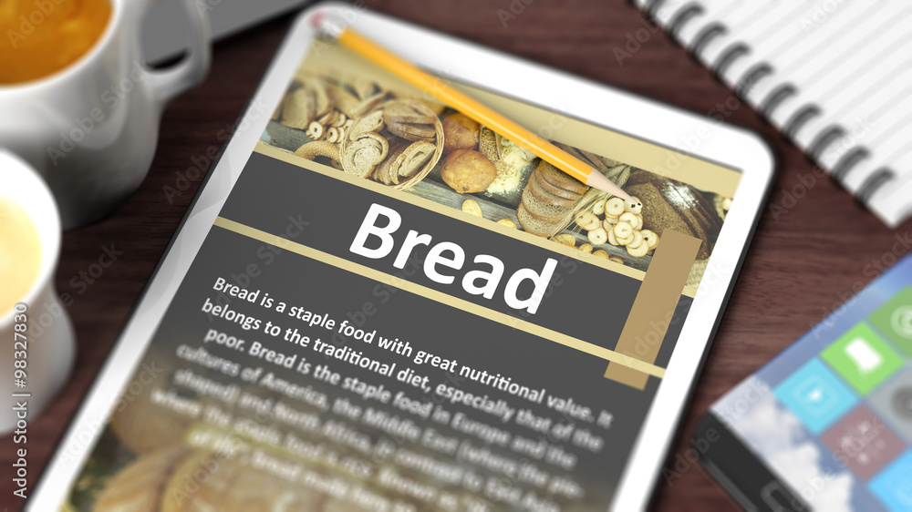 Tabletop with various objects focused on tablet with recipe of Tabletop with various objects focused on tablet with recipe of