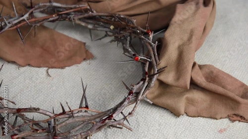 Gentle panning over crown of thorns, cloth and 3 large nails