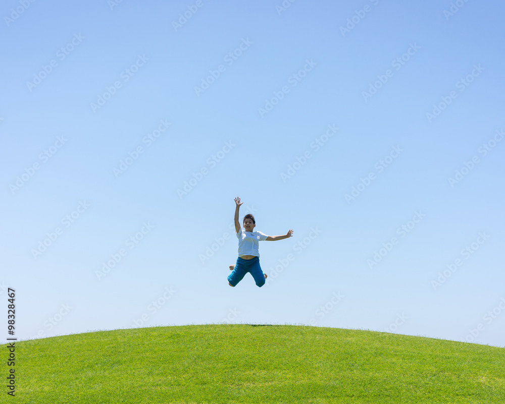 Kid jumping on beautiful field