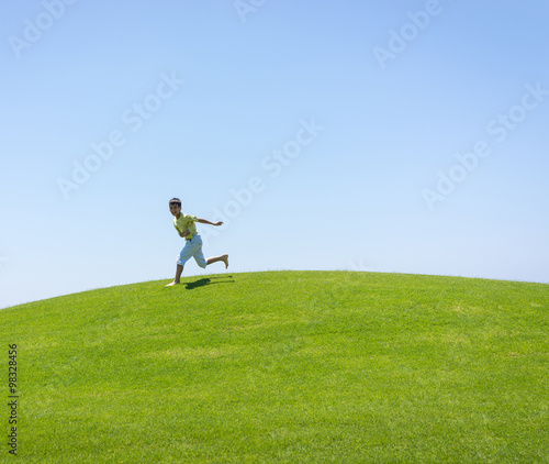 Kid jumping on beautiful field
