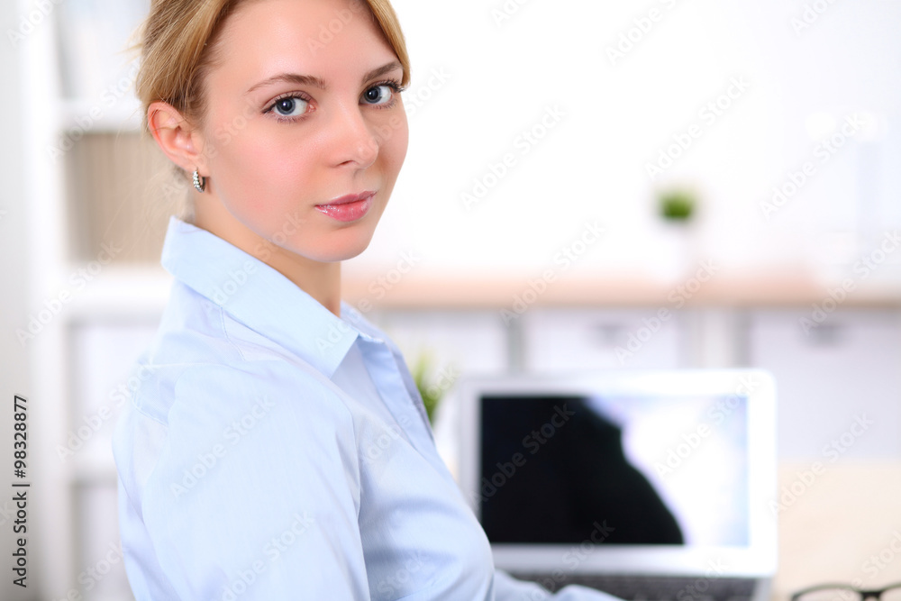 Young blonde business woman with laptop in the office. Business concept. Young blonde business woman with laptop in the office. Business concept.