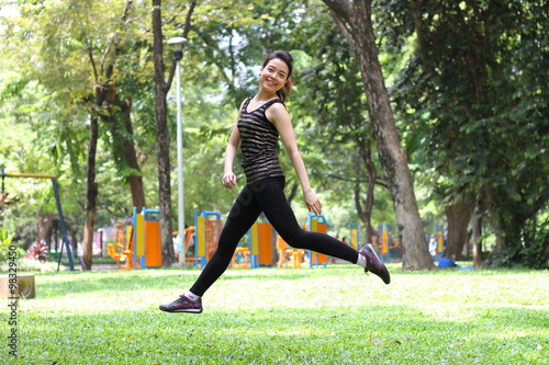 Portrait of thai adult beautiful girl relax and smile in the park