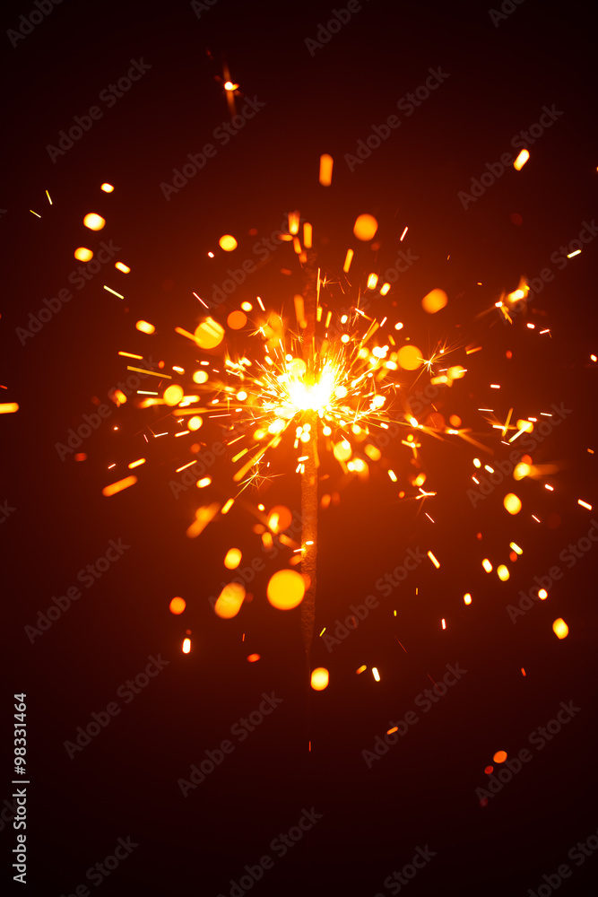 Obraz premium Christmas sparkler in haze with red light