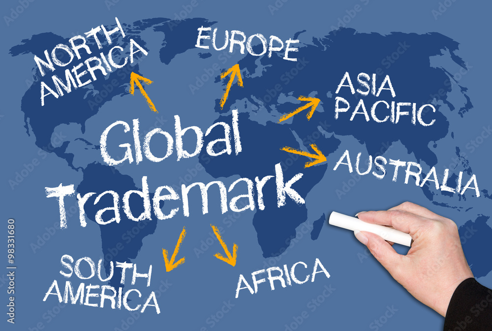 Global Trademark - blue chalkboard with female hand and text and world map in the background Global Trademark - blue chalkboard with female hand and text and world map in the background