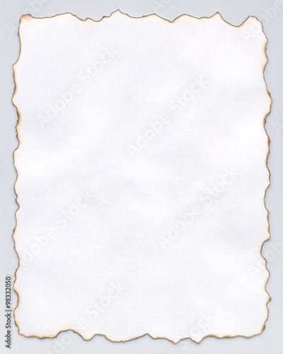Paper with fire-burnt edges. Isolated on grey background.