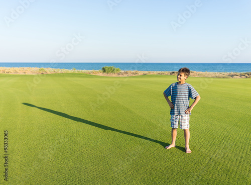 Kids with their shadows on grass