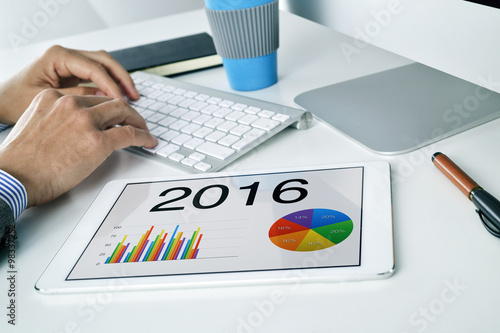 man with the economic forecast for 2016 in his tablet