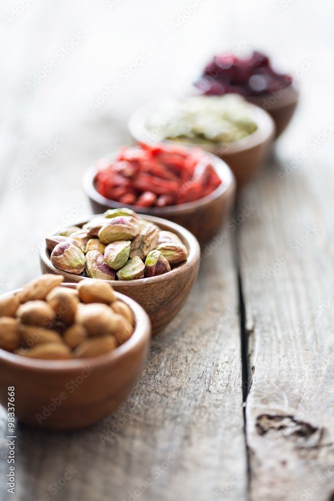 Variety of nuts and dried fruits in small bowls Variety of nuts and dried fruits in small bowls