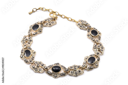 gold bracelet with black stone on a white background