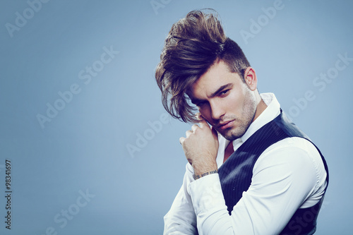 Handsome man with modern hairstyle in studio