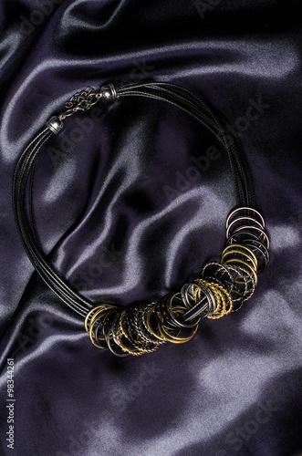 Necklace with rings on a silk background