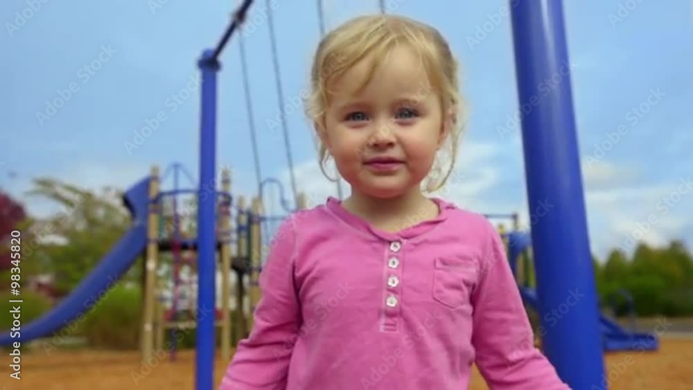 Sweet little girl waves to the camera then sticks her tongue out. Sweet little girl waves to the camera then sticks her tongue out.