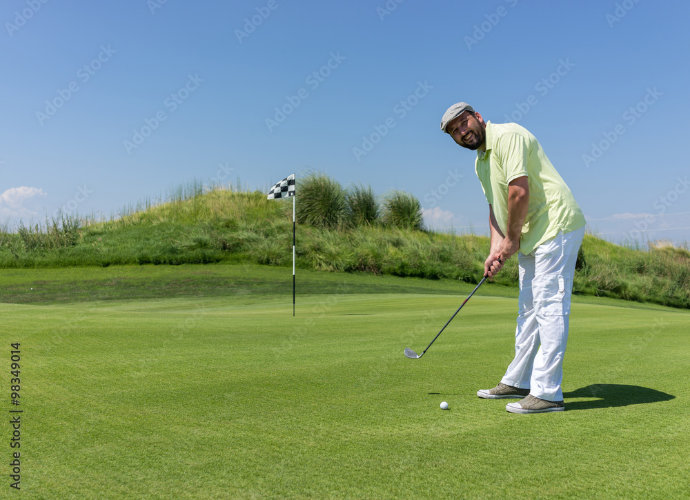 Fototapeta premium Man playing golf at club