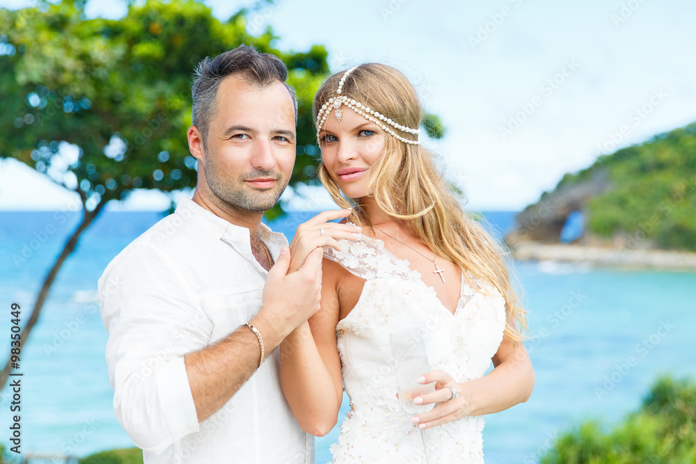 Happy bride and groom having fun on a tropical beach. Wedding an Happy bride and groom having fun on a tropical beach. Wedding an