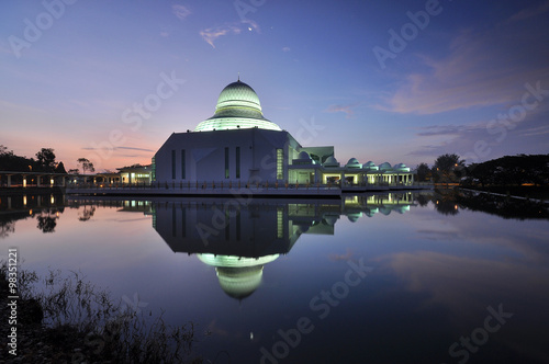 Reflection of beautiful white mosque in the lake, with awesome blue sky. Masjid An-Nur, UTP, Perak Malaysia.  photo