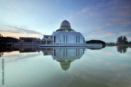 Reflection of beautiful white mosque in the lake, with awesome blue sky. Masjid An-Nur, UTP, Perak Malaysia. 