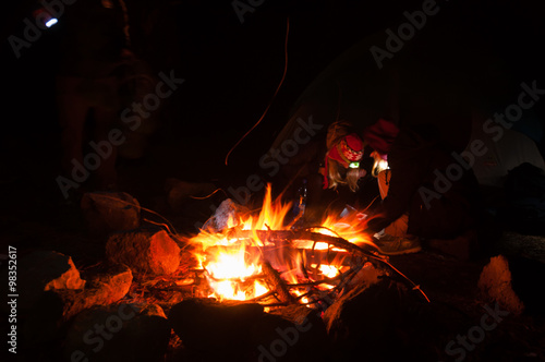 Hikers Gathered Around a campfire at night with long exposure shot