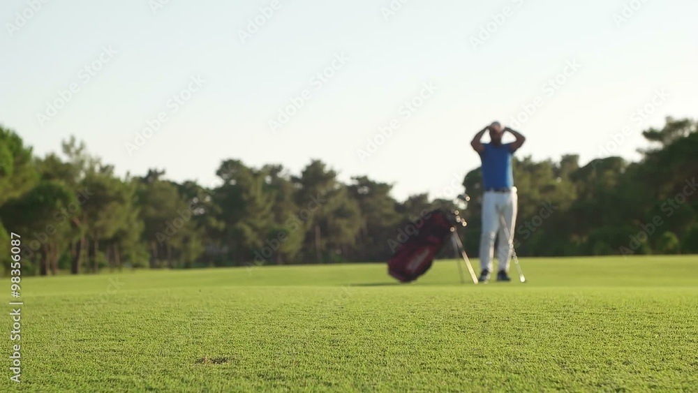 young healthy golfer hitting golf shot with club on course young healthy golfer hitting golf shot with club on course