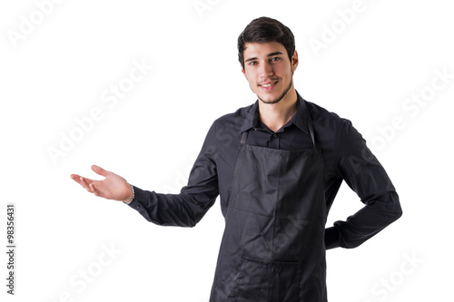 Young chef or waiter wearing black apron isolated