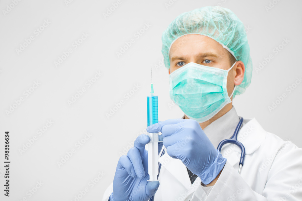 Doctor with syringe in hands preparing for injection Doctor with syringe in hands preparing for injection
