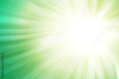 Green glitter sparkle defocused rays lights abstract background.