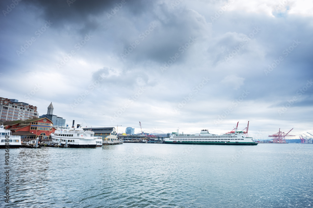 Fototapeta premium yachts and liner along dock on sea in cloudy sky