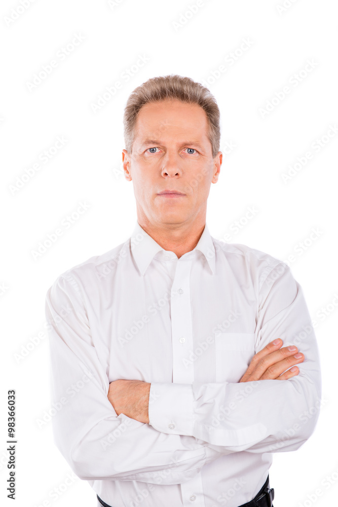 A seriuos man in a shirt with crossed hands A seriuos man in a shirt with crossed hands