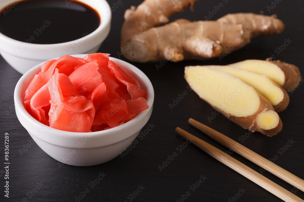 Seasoning for sushi: Soy sauce and pickled ginger close-up. horizontal
Seasoning for sushi: Soy sauce and pickled ginger close-up. horizontal