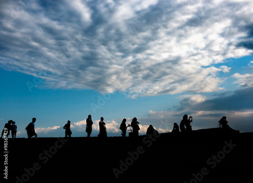 silhouettes of people admiring sunrise