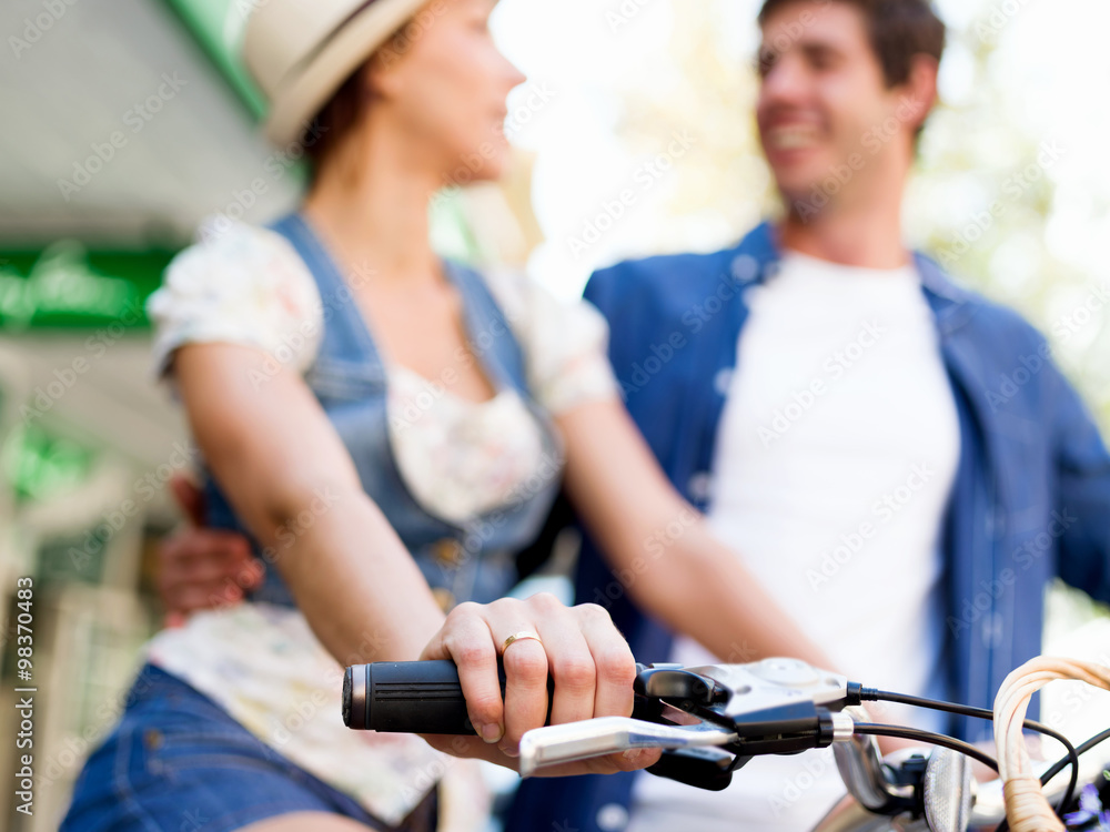 Happy couple in city with bike Happy couple in city with bike