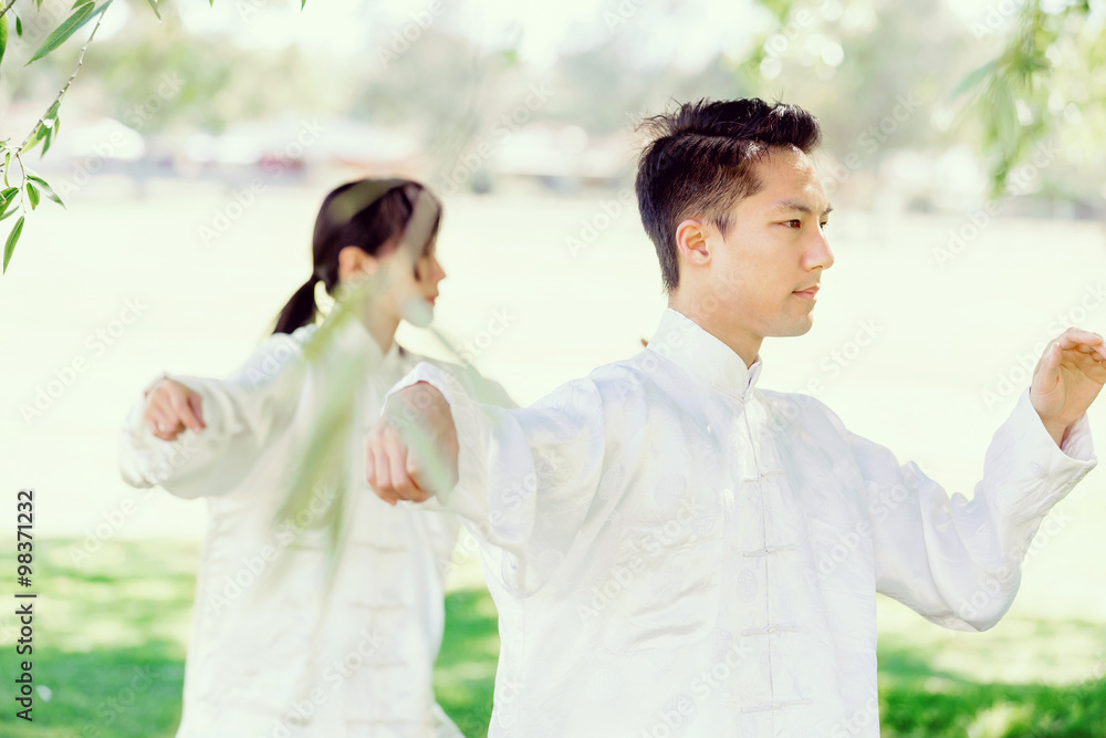 People practicing thai chi in park People practicing thai chi in park