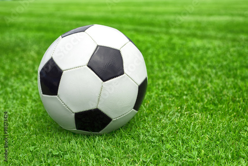 soccer ball on a green lawn close up © Studio KIVI