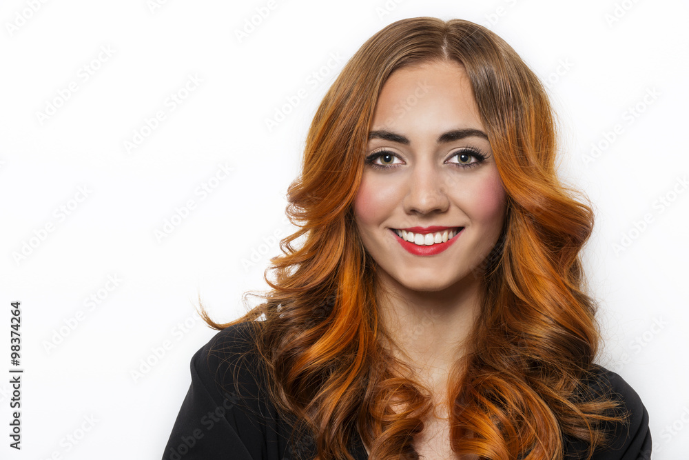 Beautiful young girl with red curly long hair and perfect teeth