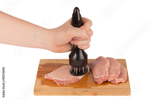 beat the meat on a wooden board on a white background