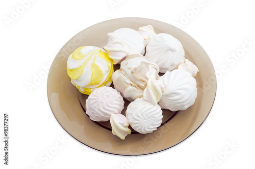 Various zefir and marshmallow on a dark glass dish
