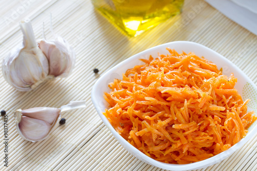 Korean carrots with ingredients for cooking : carrots grated straw, oil, pepper and garlic. Asian cuisine.  photo