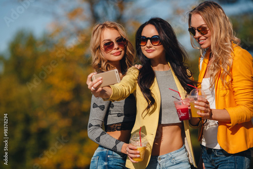 Three beautiful women take off their selfie on smartphone