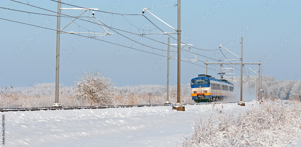 Train riding through a snowy landscape 