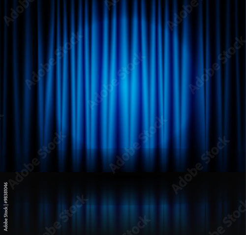 Spotlight on blue stage curtain